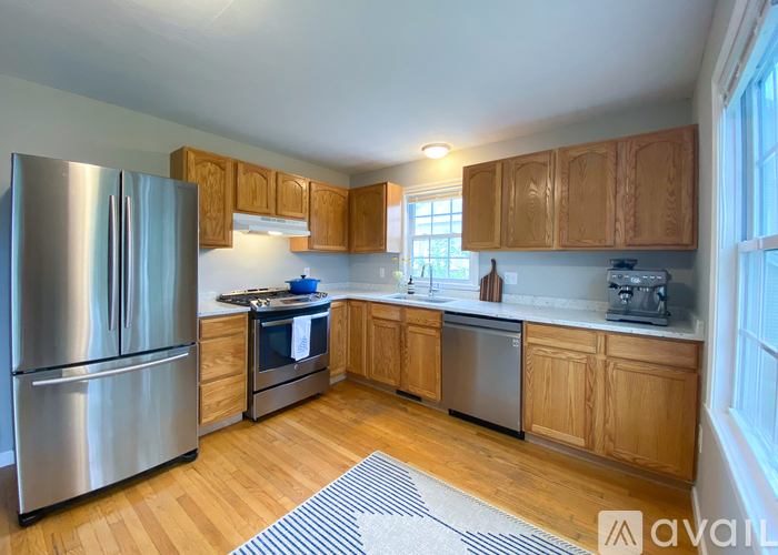 A kitchen with wooden cabinets and stainless steel appliances.