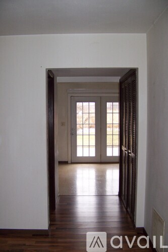 A hallway with a door at the end.