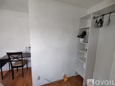 A white door with a gold handle is closed.