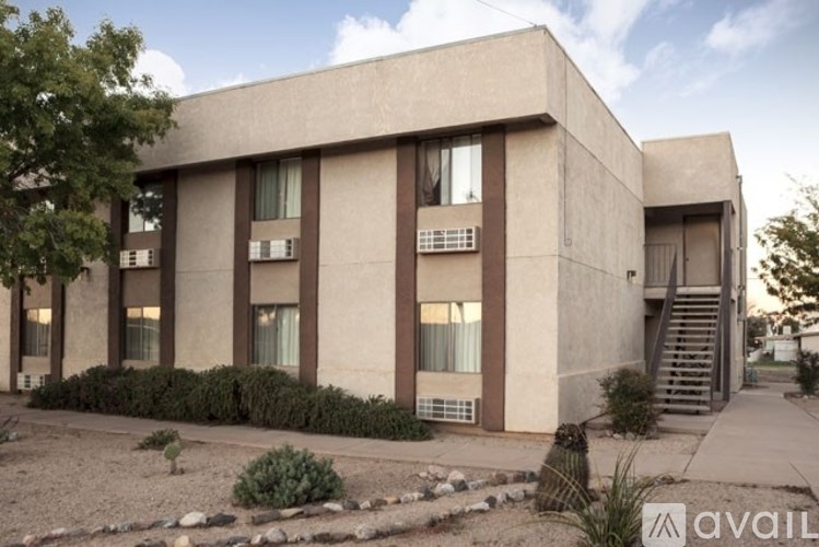 A modern building with a flat roof and a staircase leading to the entrance.