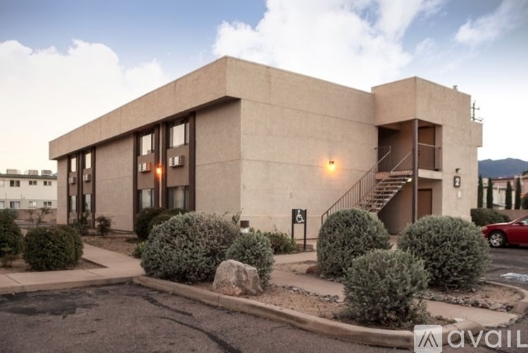A modern building with a parking lot in front.