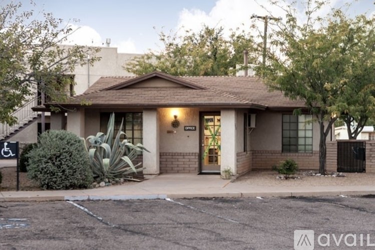 A house with a brown roof and a sign that says "AVAIL" in front of it.