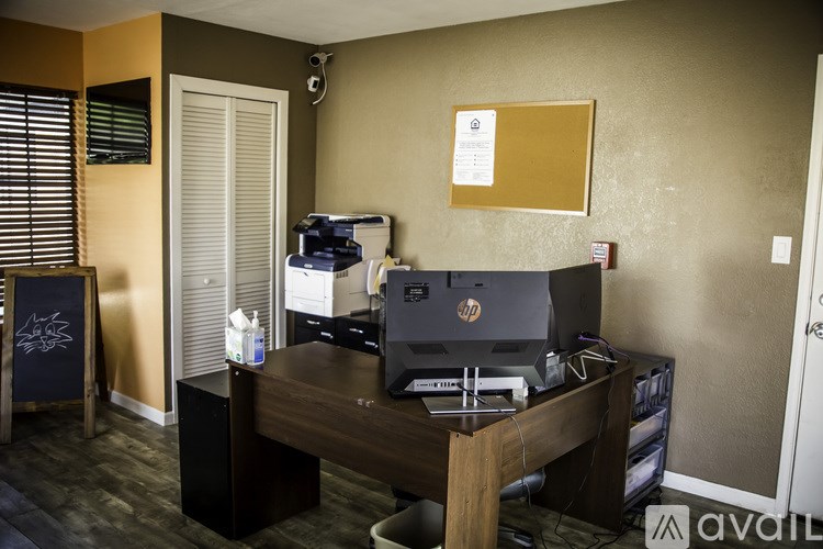 A room with a desk and a computer monitor.