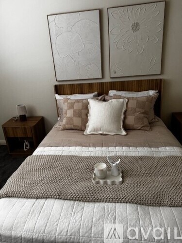 A bedroom with a bed, dresser, and window.