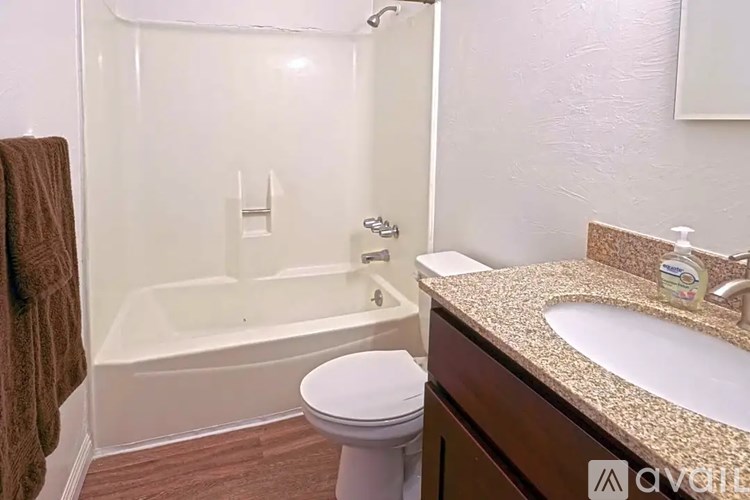 A bathroom with a toilet, sink, and bathtub.