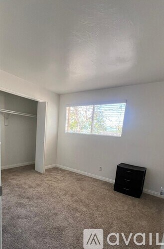 A room with a window and a filing cabinet.