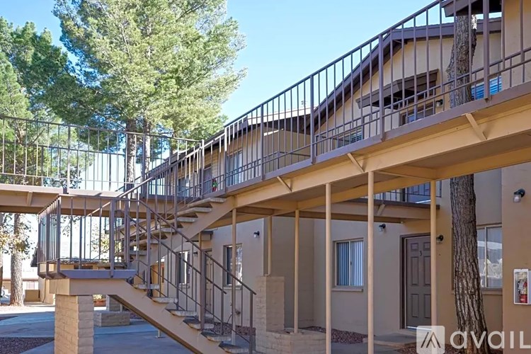 A building with a staircase and railings is available for rent.