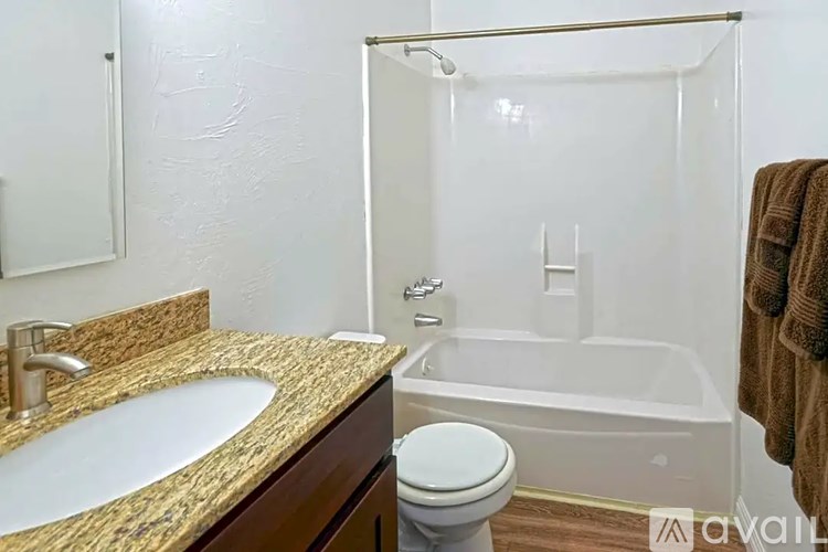 A bathroom with a sink, toilet, and bathtub.