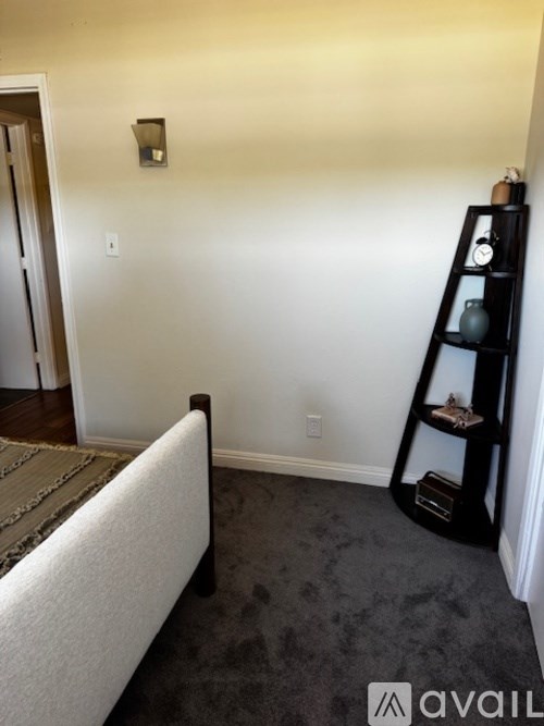 A black shelf with a few items on it.