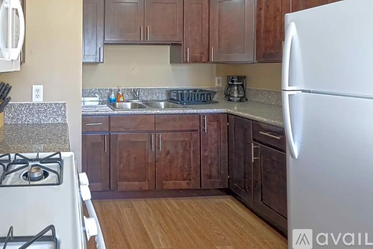A kitchen with a white stove and a white refrigerator.