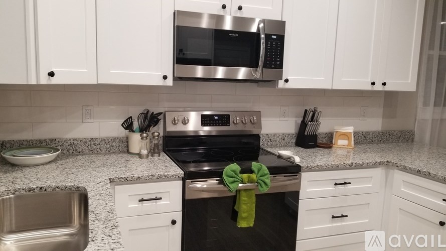 A kitchen with a stove top oven and microwave above it.