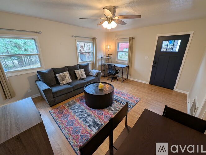 A kitchen with white cabinets and a black stove top oven.