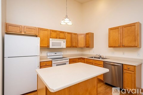 A kitchen with wooden cabinets and a white refrigerator.