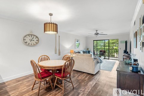 A dining room with a round table and chairs.