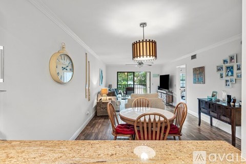 A dining room with a table set for four.
