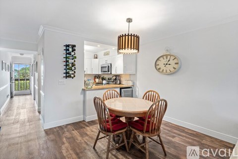 A dining room with a wooden table and chairs.