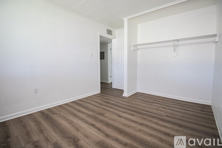 A room with a wooden floor and white walls.