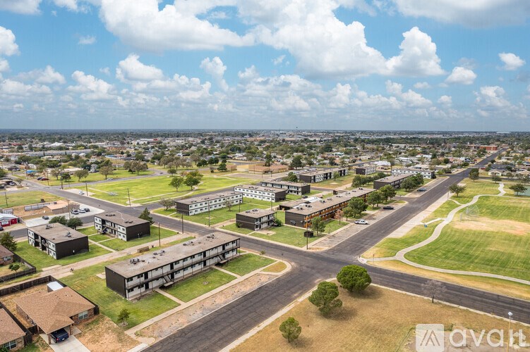 A large building complex with a parking lot in front of it.
