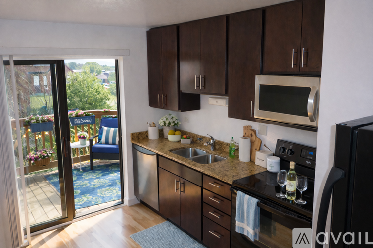 A kitchen with black cabinets and a sink.