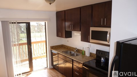 A kitchen with black cabinets and a sink.