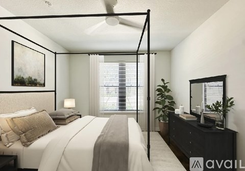 A bedroom with a four poster bed and a ceiling fan.