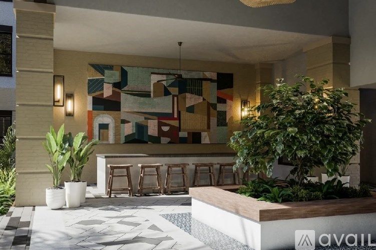 A modern outdoor seating area with a colorful mosaic wall and a wooden bench.