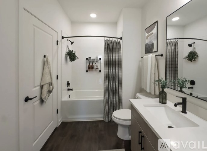 A bathroom with a toilet, sink, and shower.