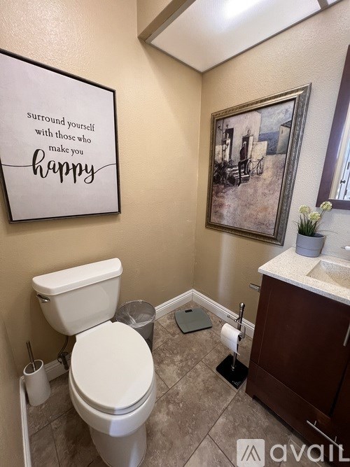 A bedroom with two beds and a nightstand in between.