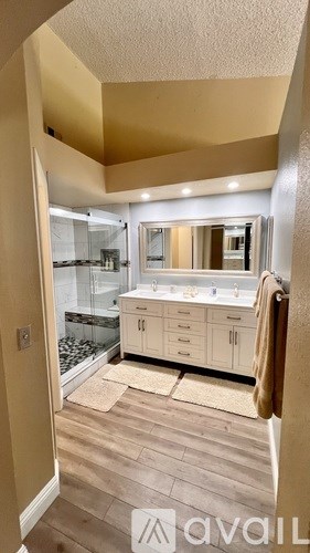 A bathroom with a vanity and a mirror.