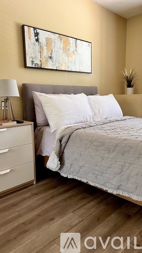 Two jars of cotton balls and cotton buds are on a table.