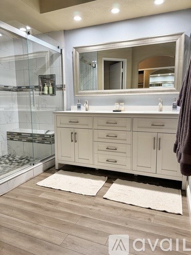 A patio with a white couch and a black vase.