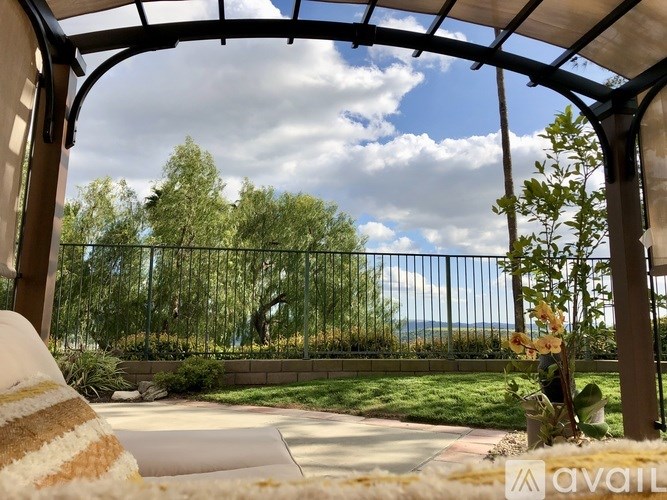 A patio with a view of the sky and trees.