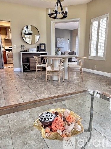 A cactus in a grey pot on a wooden table.
