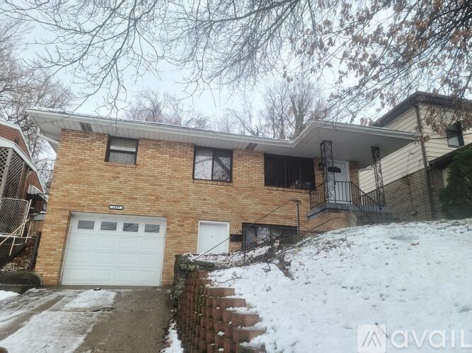 A house with a garage and a driveway covered in snow.
