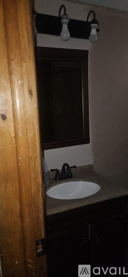 A bathroom with a sink and mirror.