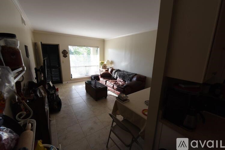 A living room with a couch, a chair, and a table.