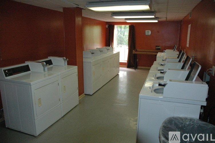 A room with red walls and white appliances.