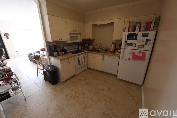 A kitchen with a refrigerator covered in magnets and notes.