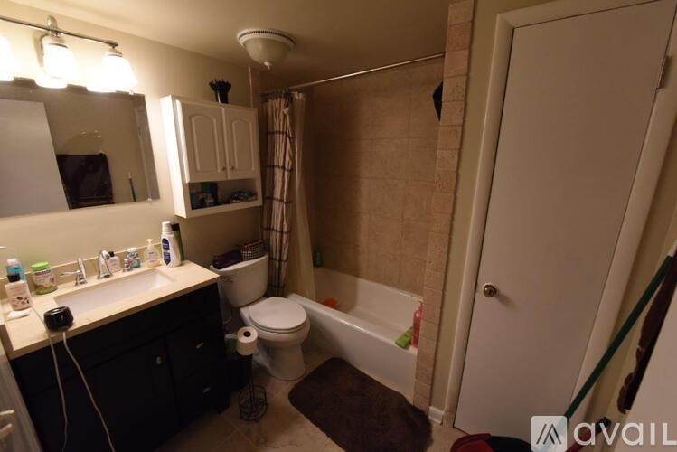 A bathroom with a toilet, sink, and bathtub.