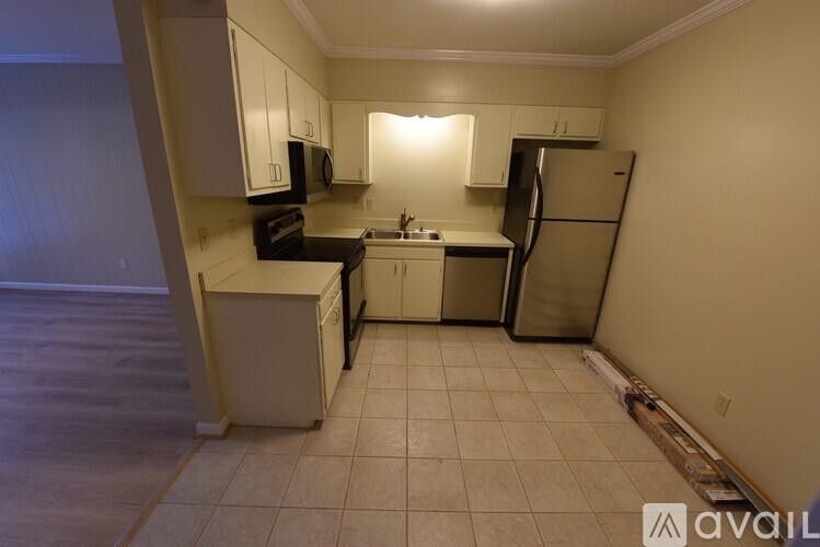 A kitchen with white cabinets and appliances.