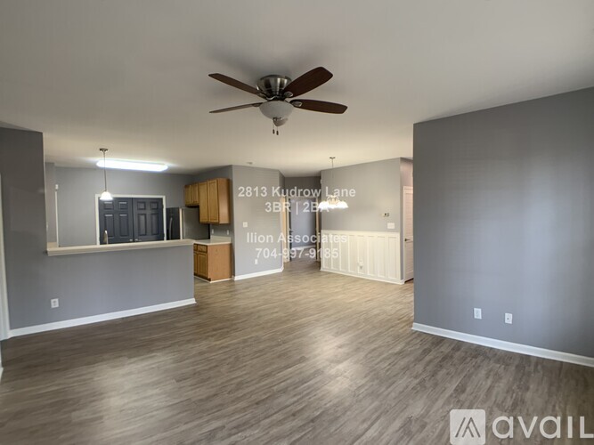 A spacious room with a ceiling fan and a sign that reads "2813 Kudrow Lane 3BR 12B".