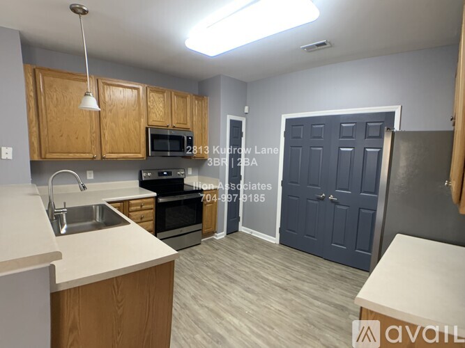 A kitchen with a sink, microwave, and oven.