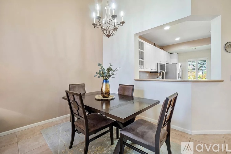 A dining room with a table set for two.