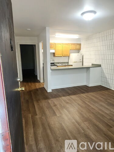 A kitchen with a white stove and a white sink.