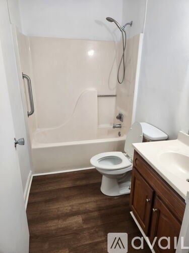A bathroom with a toilet, sink, and bathtub.