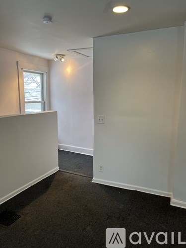 A room with white walls and a window.