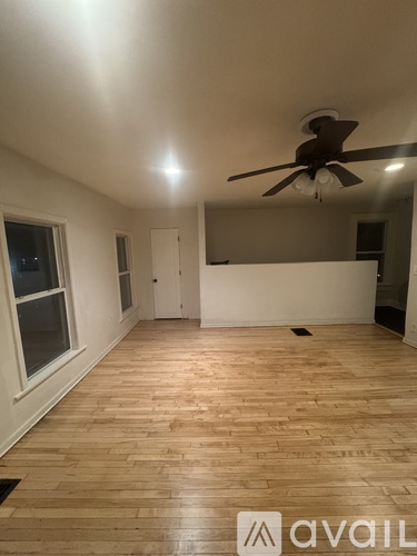 Two white doors in a room with grey walls.