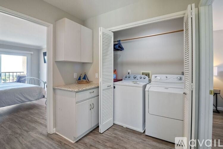 A small laundry room with a washer and dryer.
