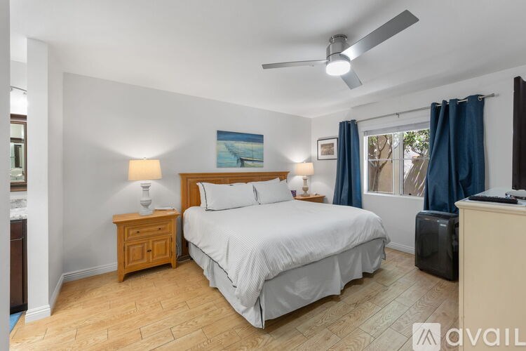 A bathroom with a marble countertop and a glass shower stall.