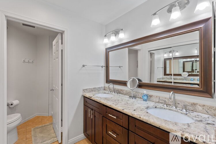 A street view of a residential area with a crosswalk and palm trees.